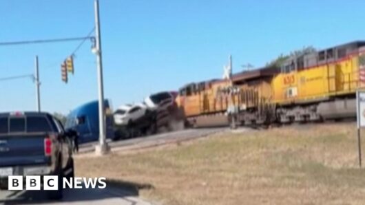 Watch: Moment train collides with lorry carrying vehicles